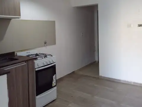 Departamento dos ambientes con pequeño patio interno y cochera