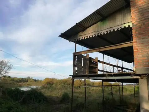 Gran Terreno con Cabaña sobre la R1 y al río 